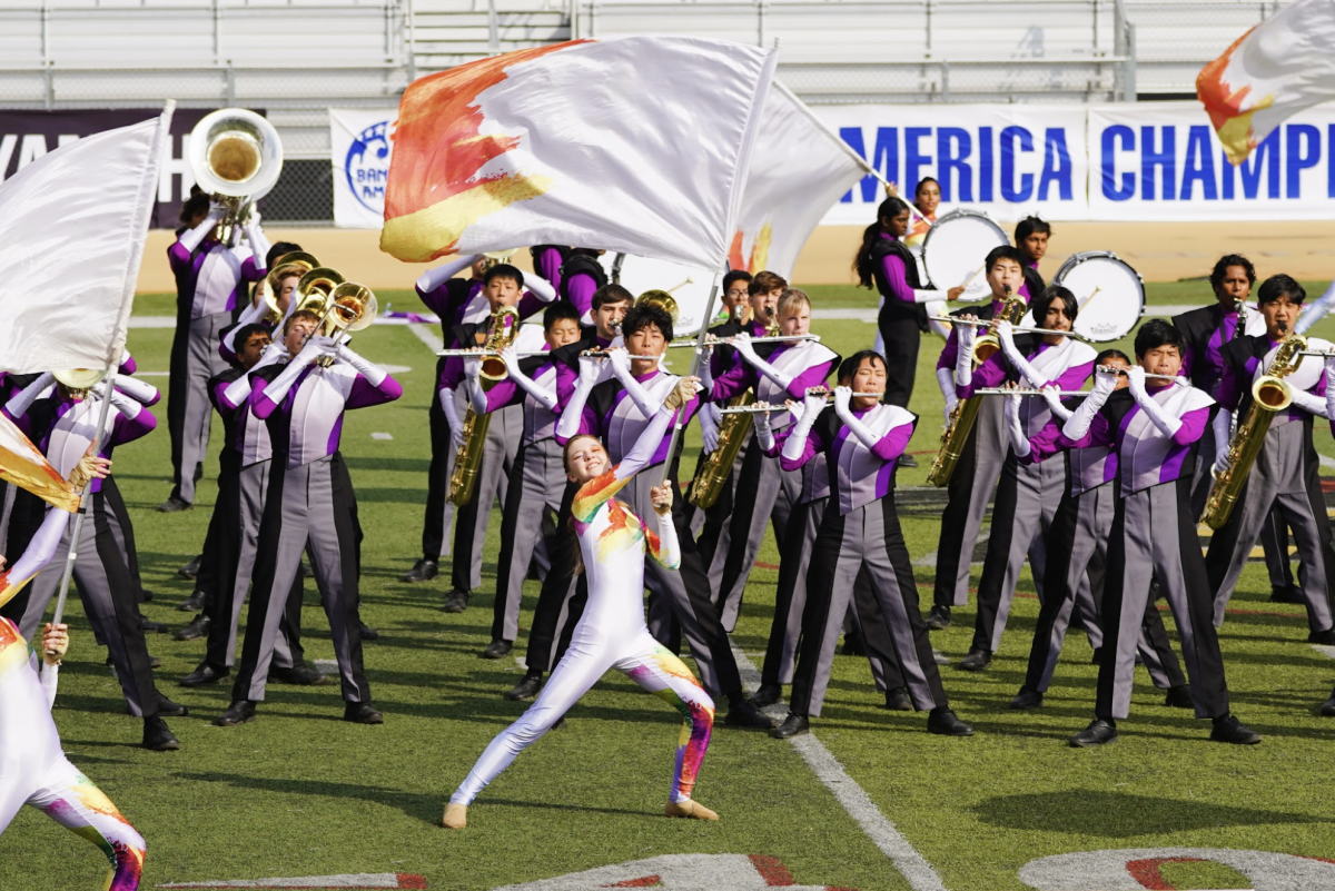 Alexa Stone ('27) performs the first ensemble feature with the Band and Color Guard.